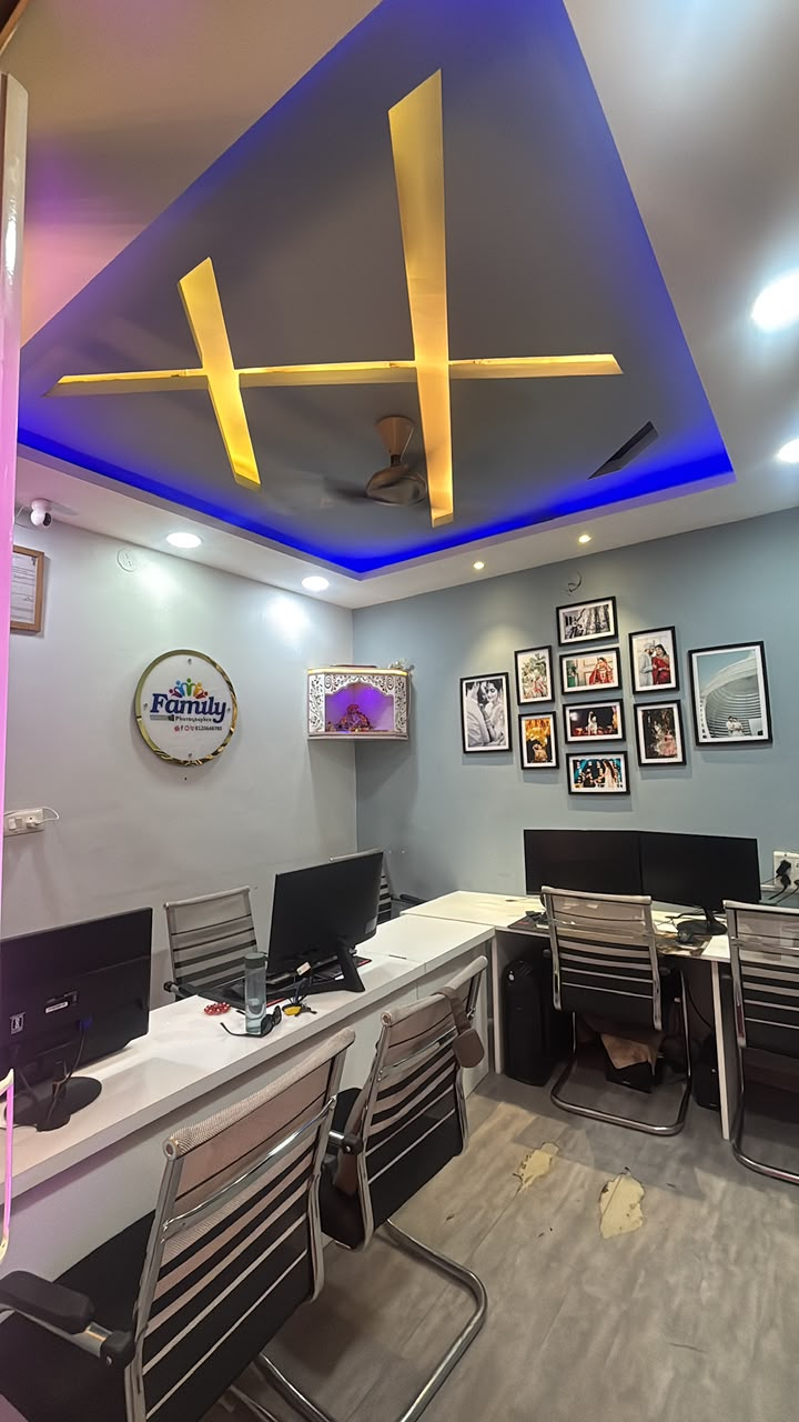 Editing workstations with photo wall inside the Family Photographer studio, Indore