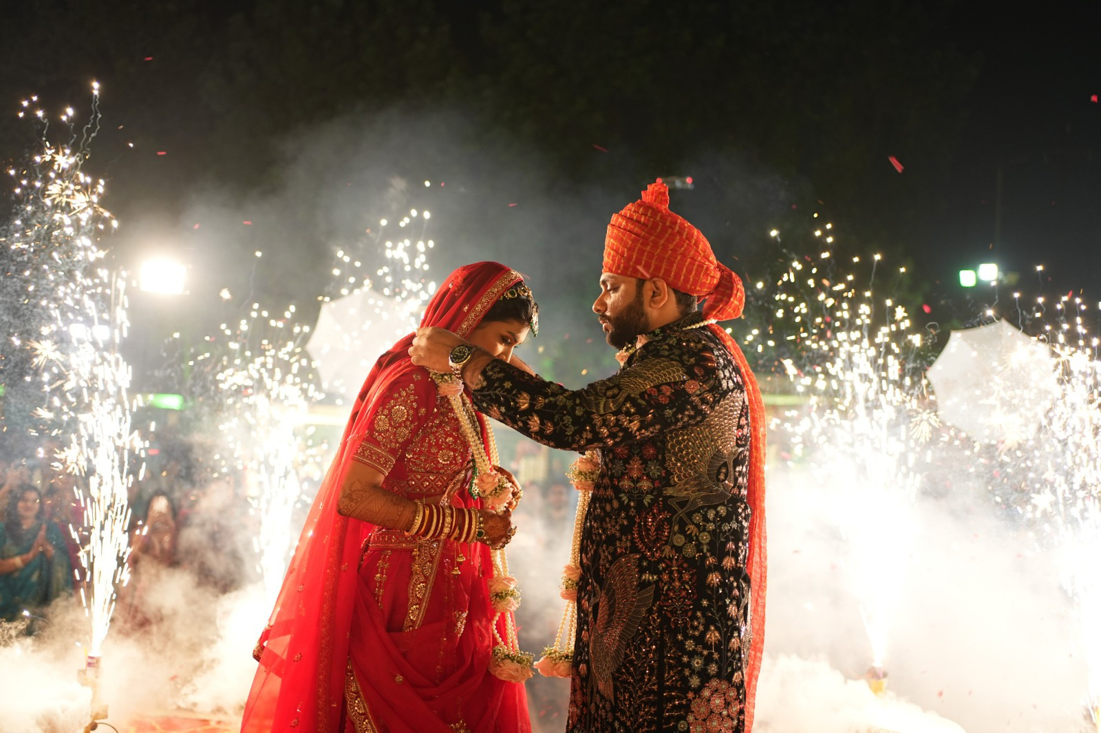 Aayushi and Vedant during their wedding ceremony with sparkling lights