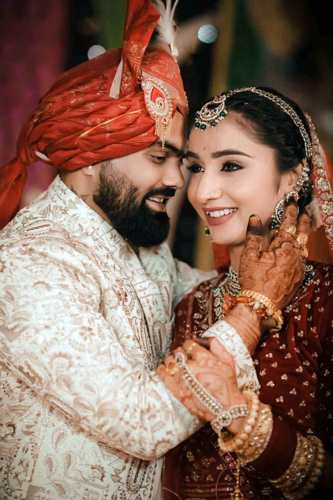 Aakash and Kannu smiling together in their wedding attire