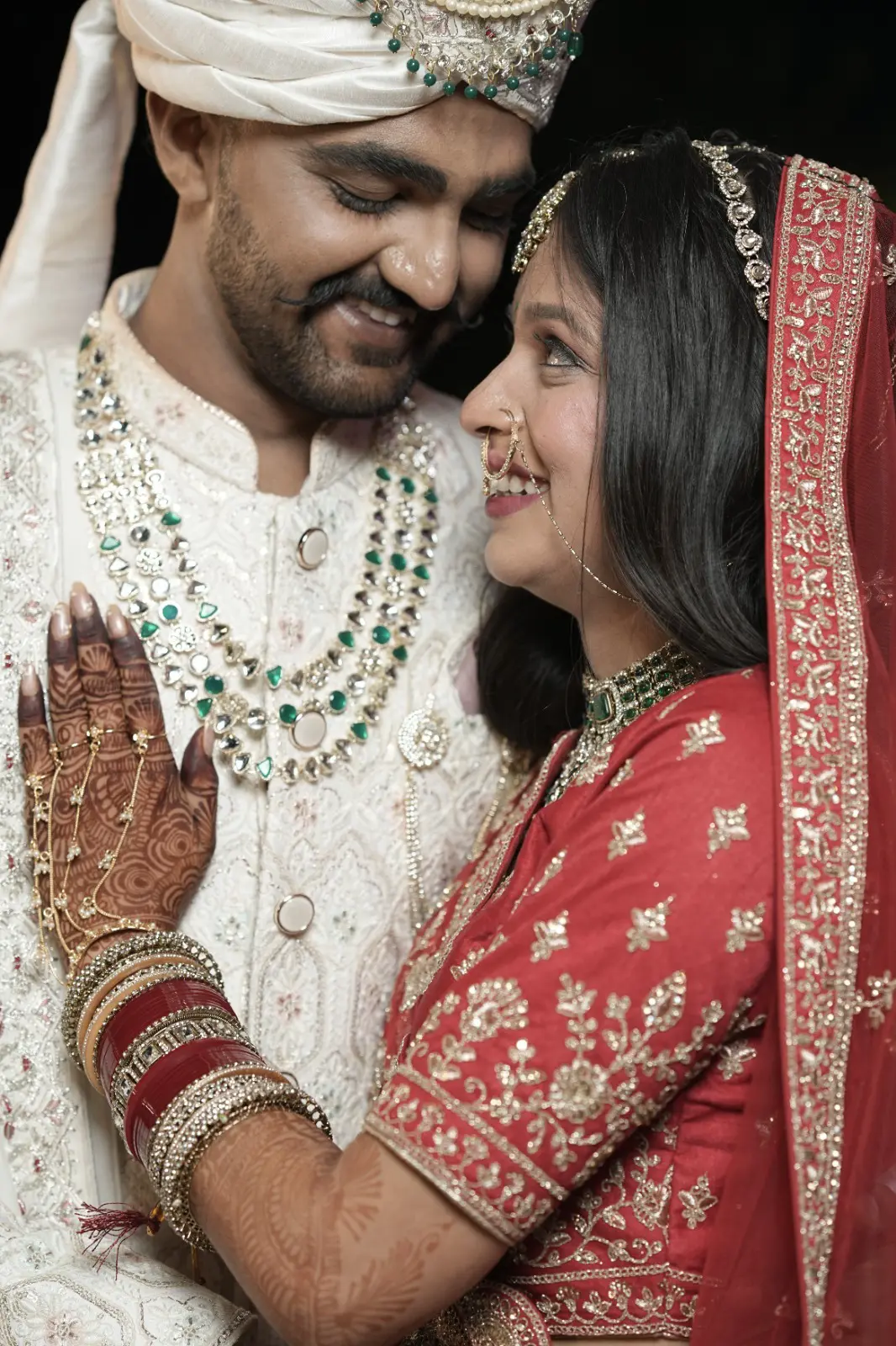 Sachin and Priya looking at each other in their wedding attire