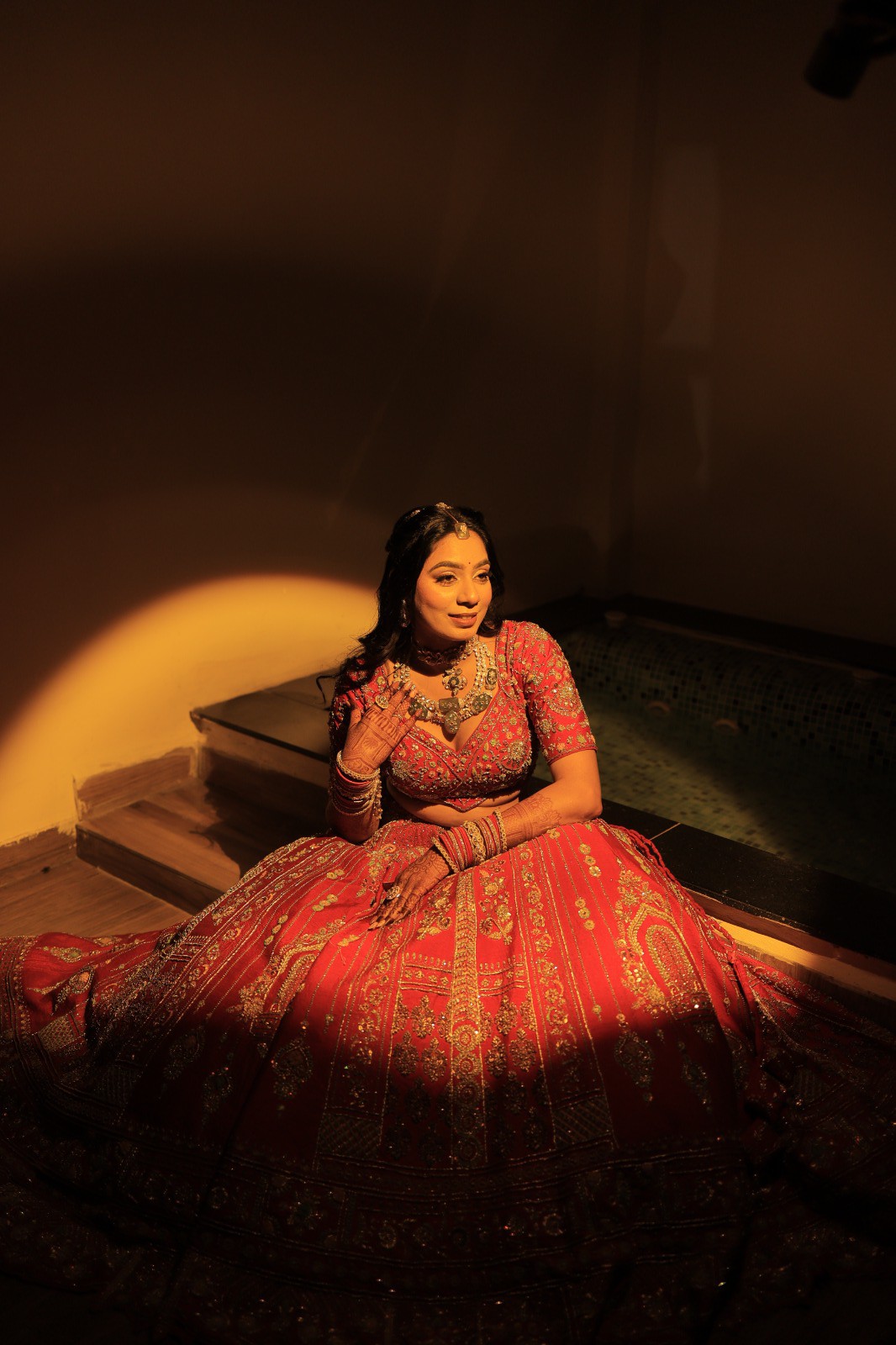 Bride in red under a dramatic spotlight